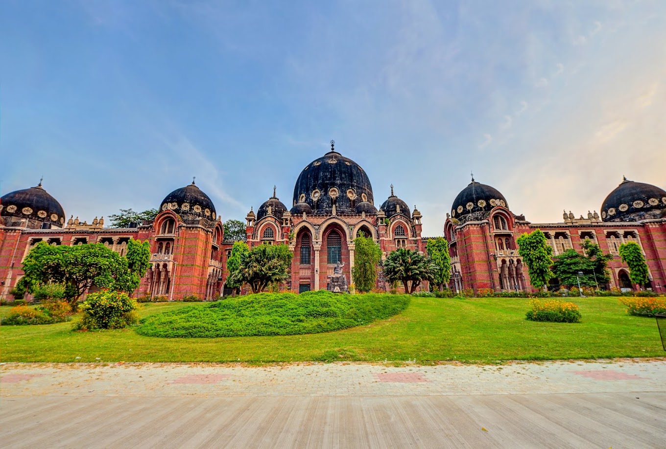 The Maharaja Sayajirao University of Baroda — heritage main building with red-brick Indo-Saracenic façade and seven domes.